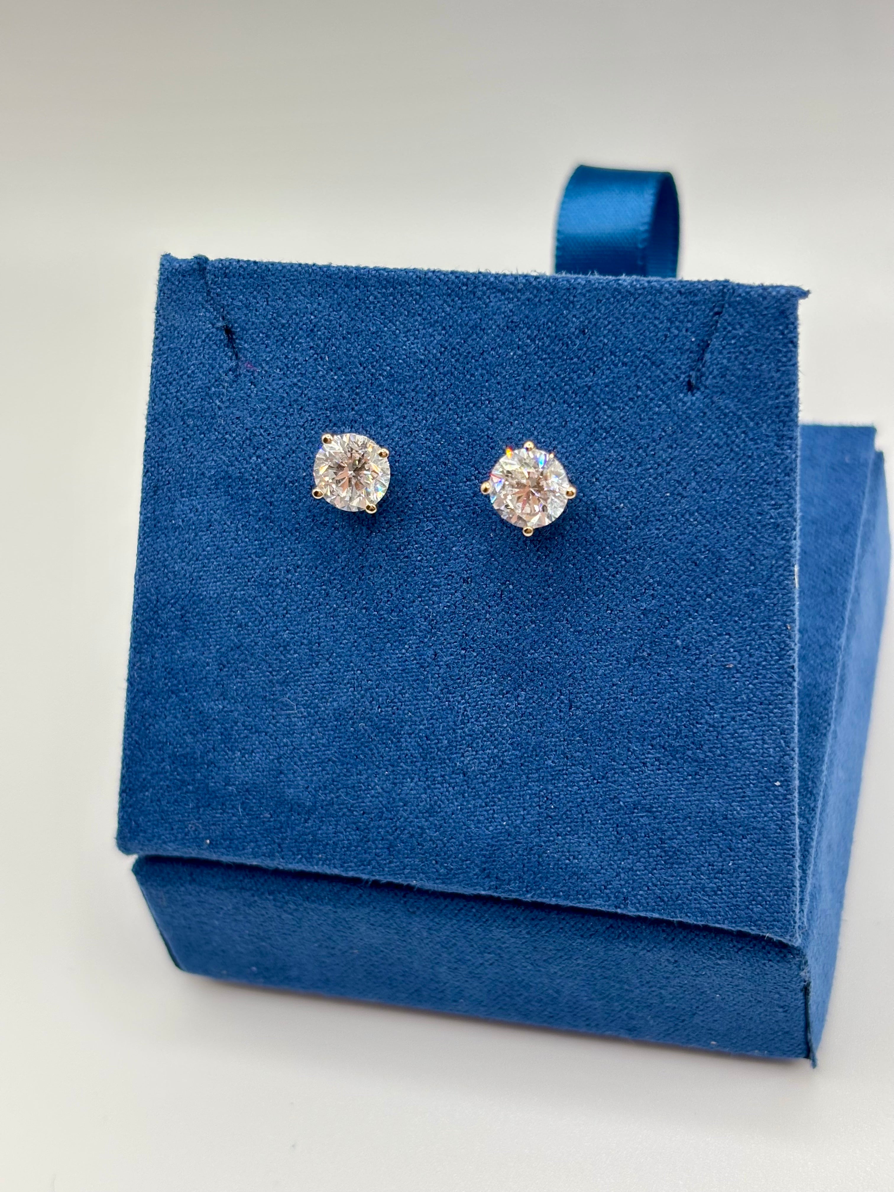 2 carat total weight lab diamond stud earrings displayed on blue jewelry box, angled view