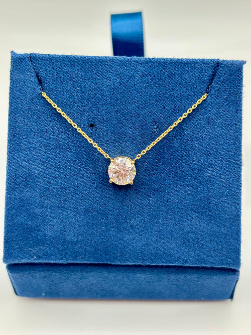 Lab diamond solitaire necklace displayed on blue jewelry box