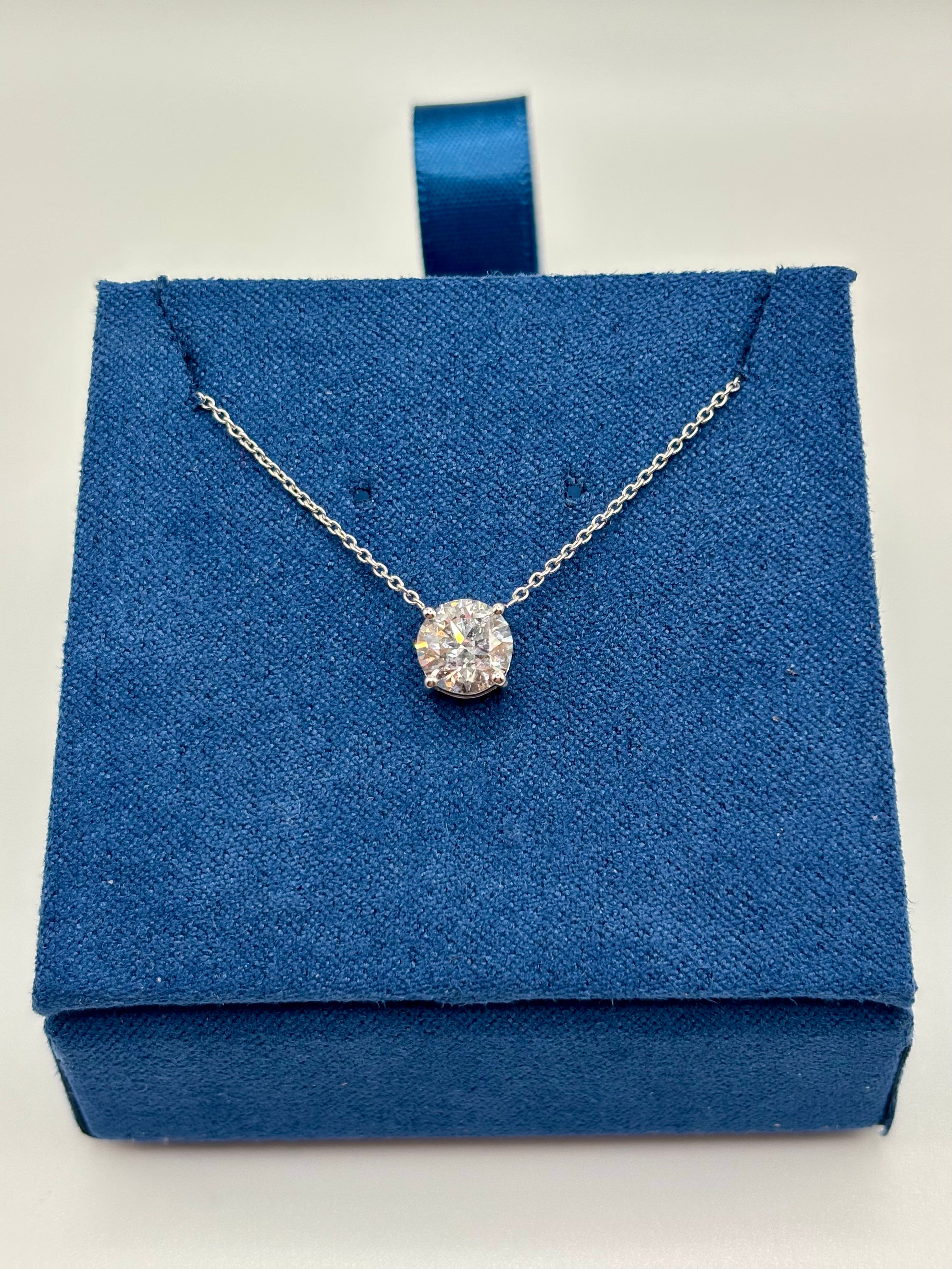 Round brilliant lab diamond pendant on 14K white gold cable chain, front view on blue box