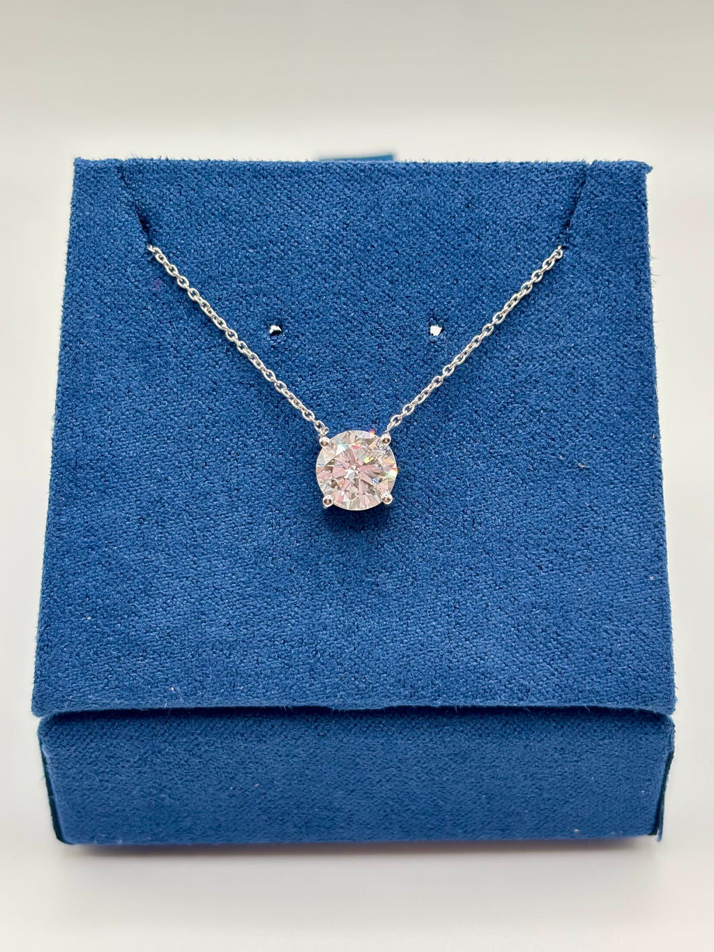 1.5 carat lab grown diamond solitaire necklace in 14K white gold on blue box, full view