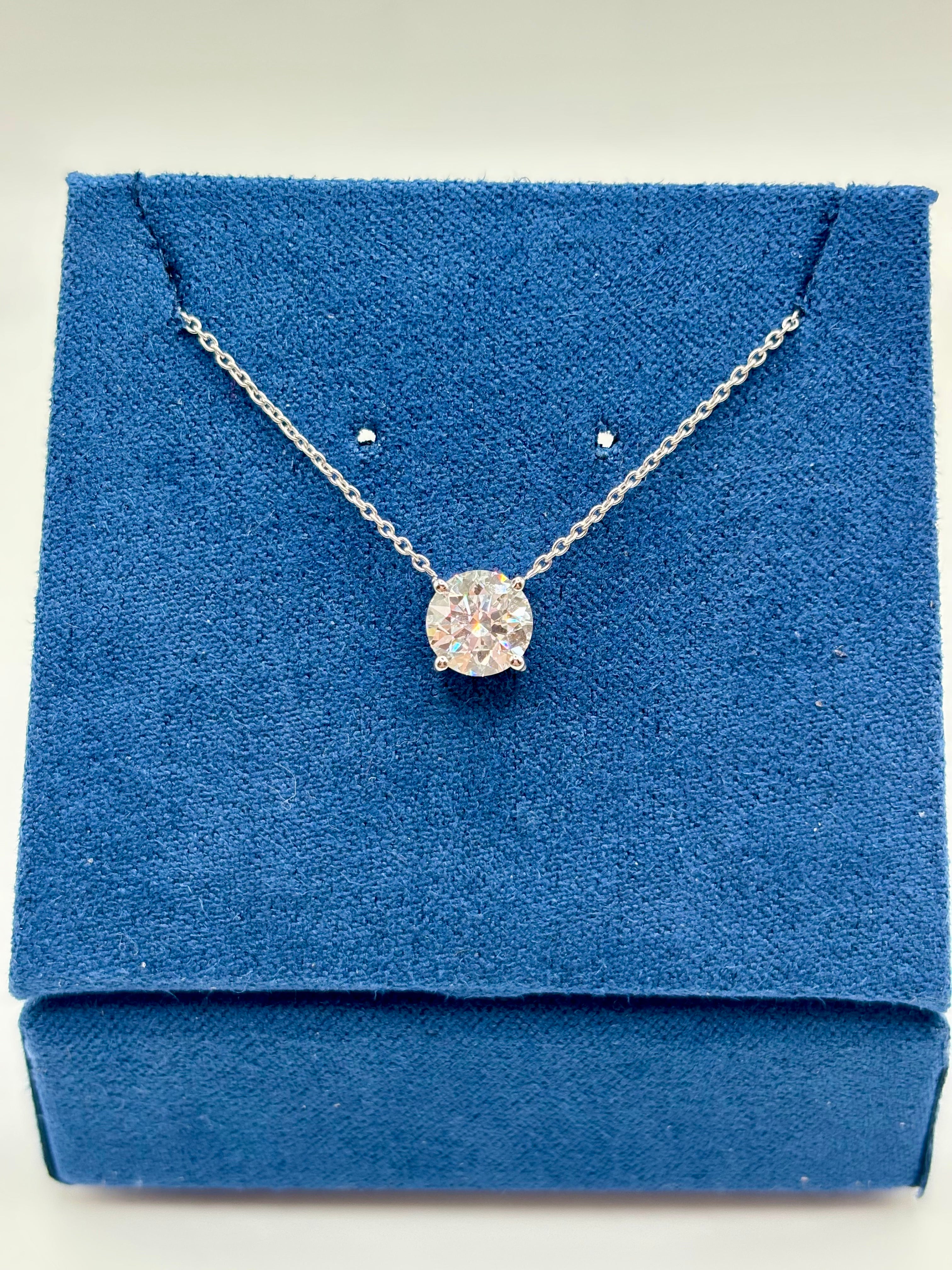 1.5 carat lab grown diamond station necklace in 14K white gold on blue box, close-up