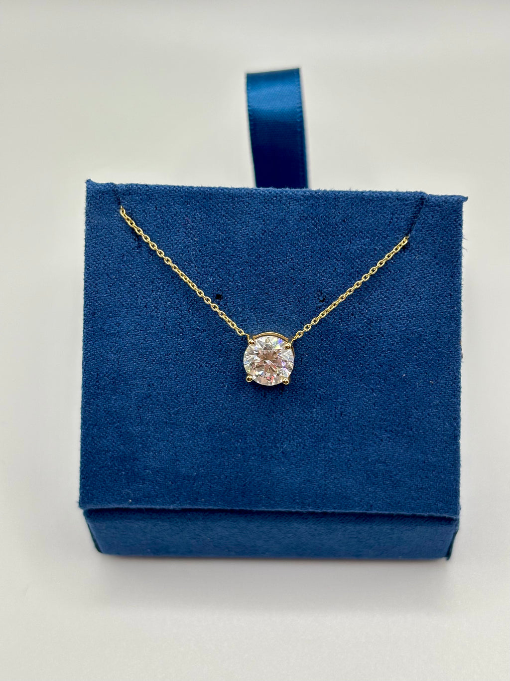 Round brilliant pink lab diamond pendant on 14K yellow gold chain, zoomed in