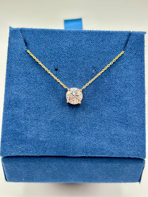 1 carat lab diamond solitaire station necklace in 14K yellow gold on blue velvet box