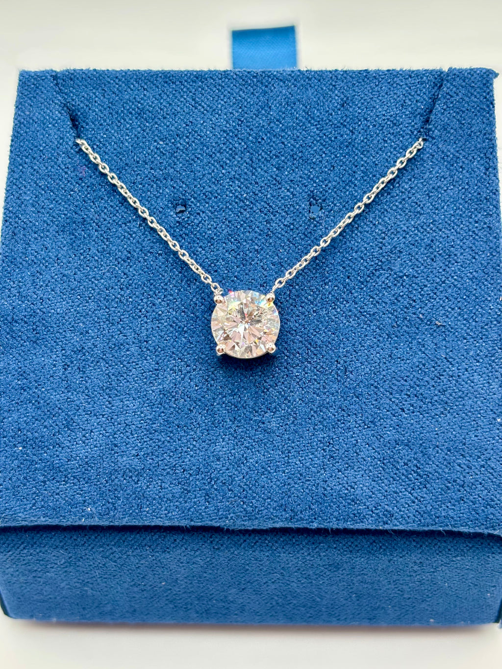 1.5ct lab diamond pendant on 14K white gold cable chain, top view on blue box