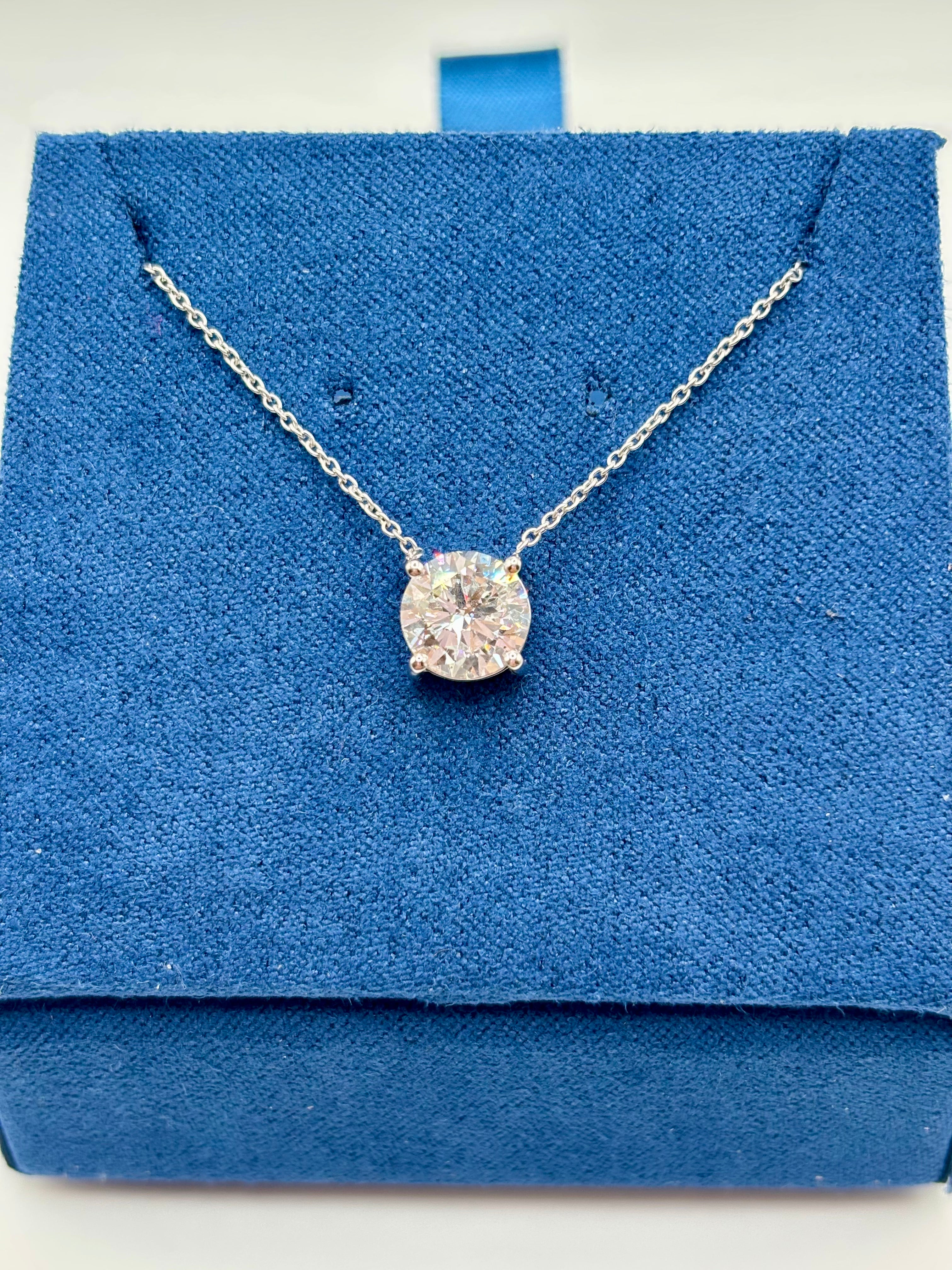 1.5ct lab diamond pendant on 14K white gold cable chain, top view on blue box