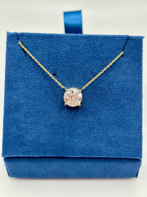 Pink lab diamond solitaire necklace on blue jewelry box, close-up