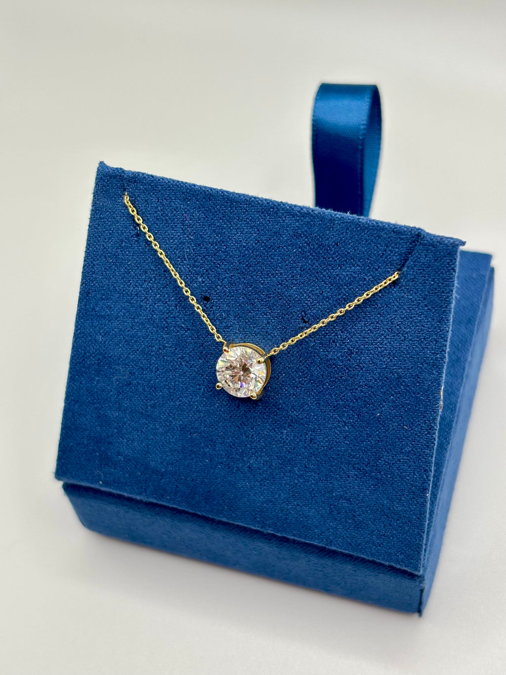 1.5ct pink lab diamond station necklace displayed on blue velvet box