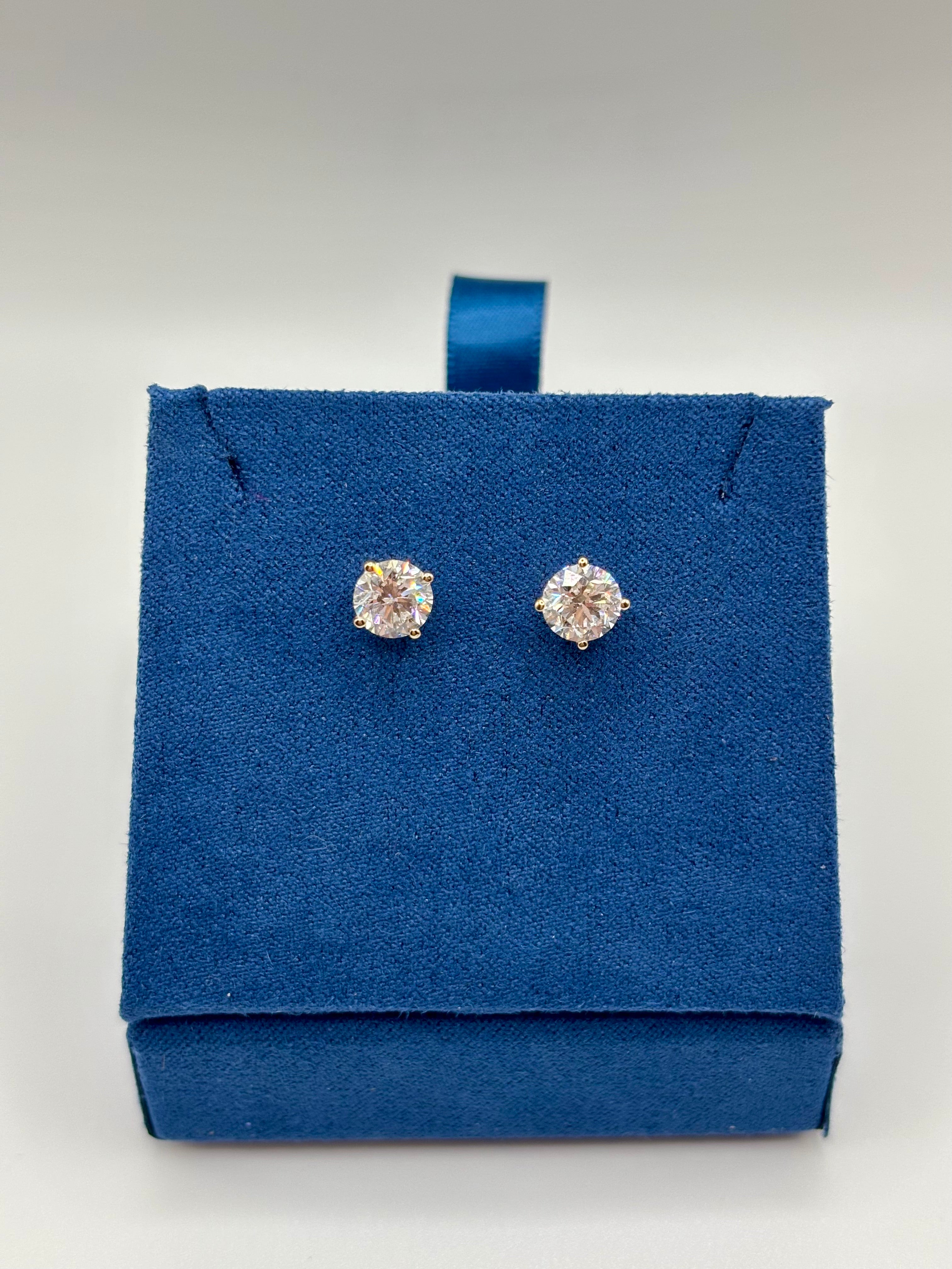 2 CTW lab grown diamond studs in 14K yellow gold on blue velvet box, close-up