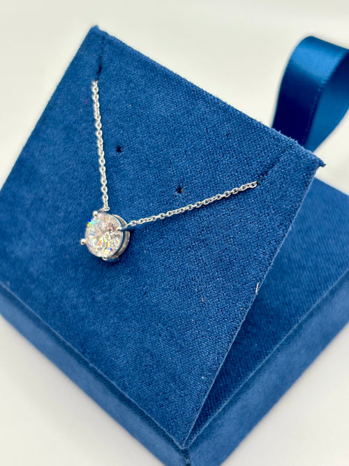 1.5 carat lab diamond solitaire station necklace in 14K white gold on blue velvet box, angled view
